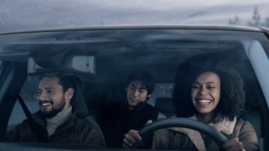 Three passengers riding in a vehicle and smiling | Bedford Nissan in Bedford OH